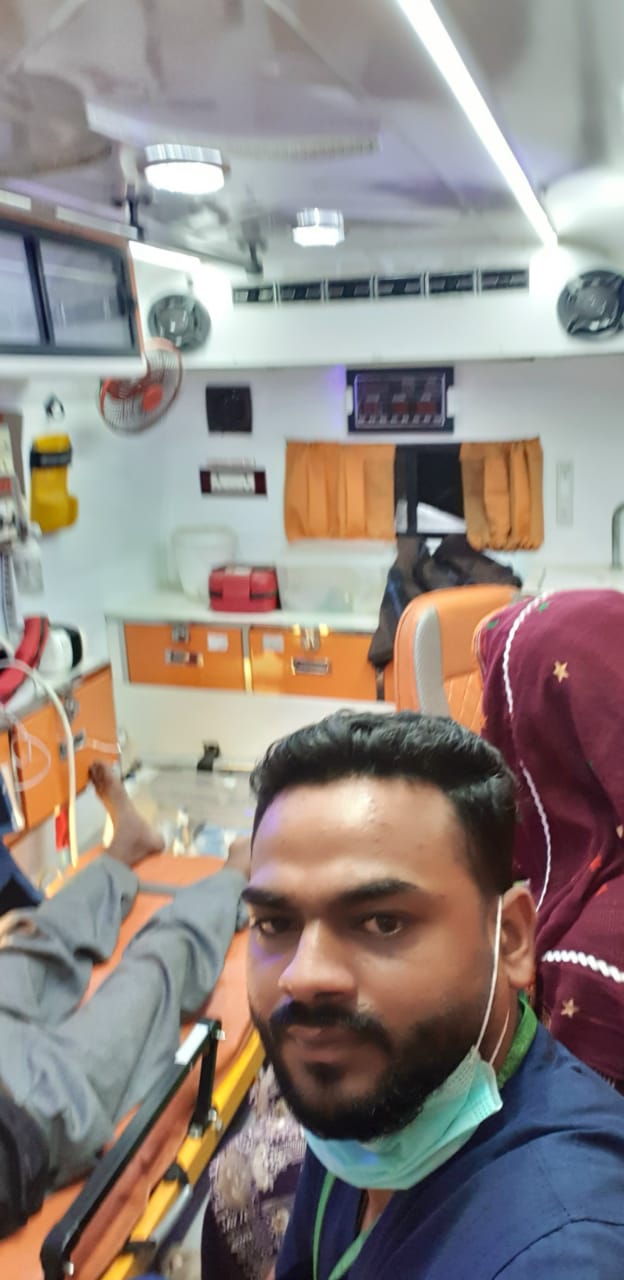 Home care attendant beside patient bed